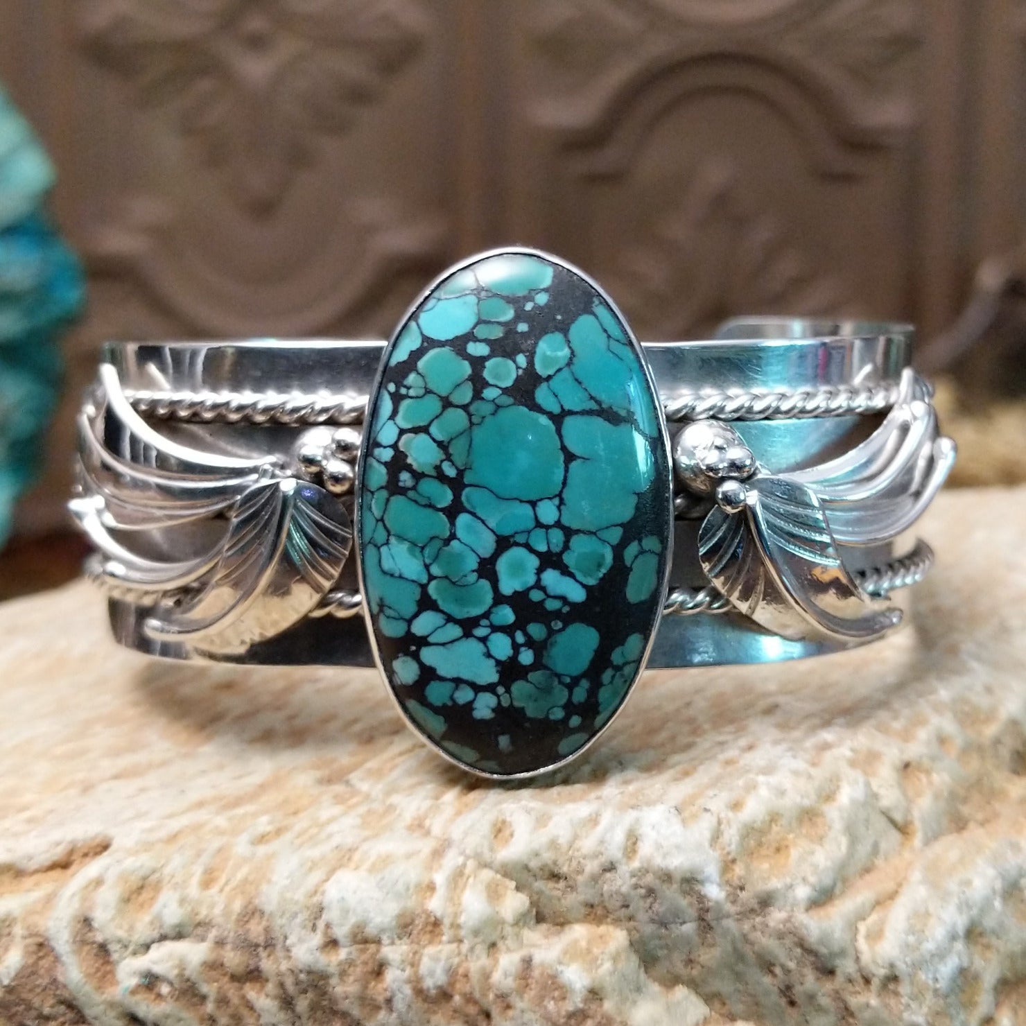 Sterling silver cuff bracelet with Chinese turquoise set in the large, oval bezel and feather silverwork on the band.