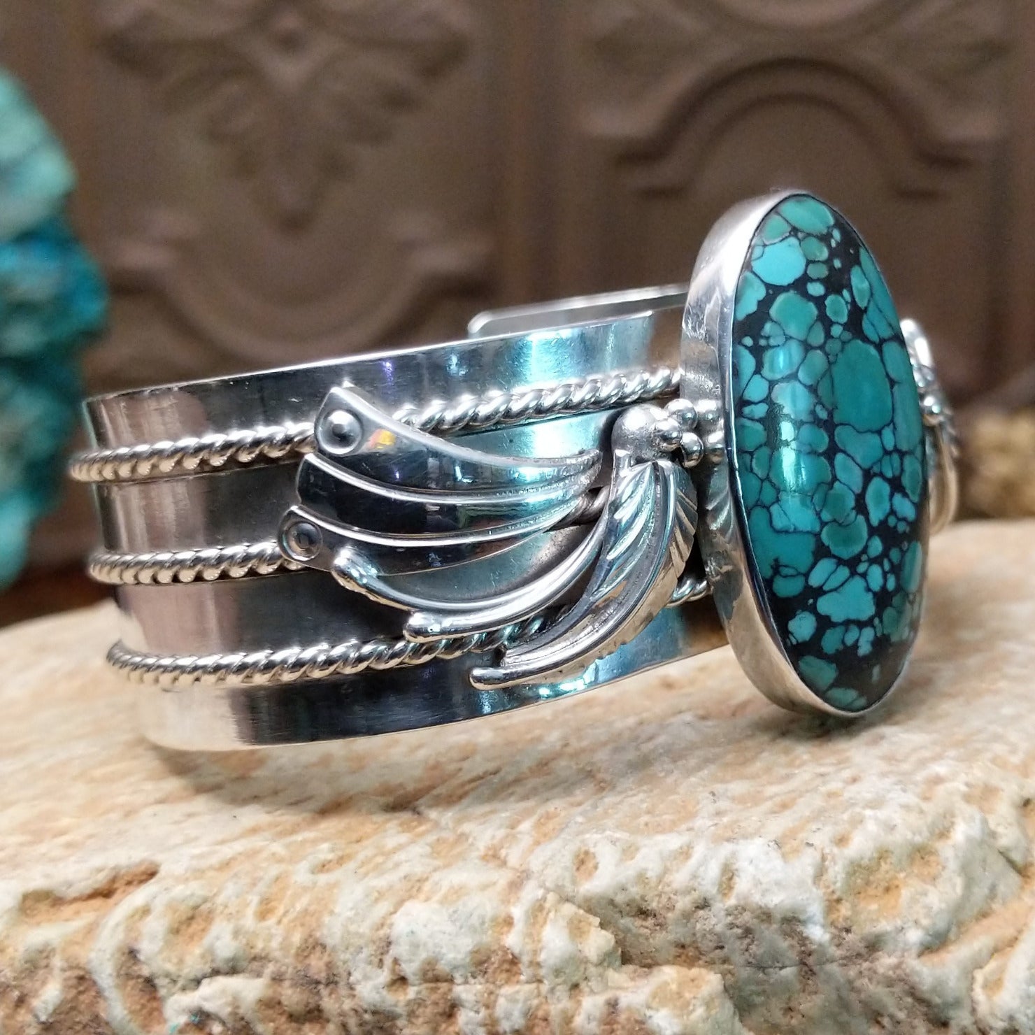 Sterling silver cuff bracelet with Chinese turquoise set in the large, oval bezel and feather silverwork on the band.