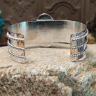 Sterling silver cuff bracelet with Chinese turquoise set in the large, oval bezel and feather silverwork on the band.