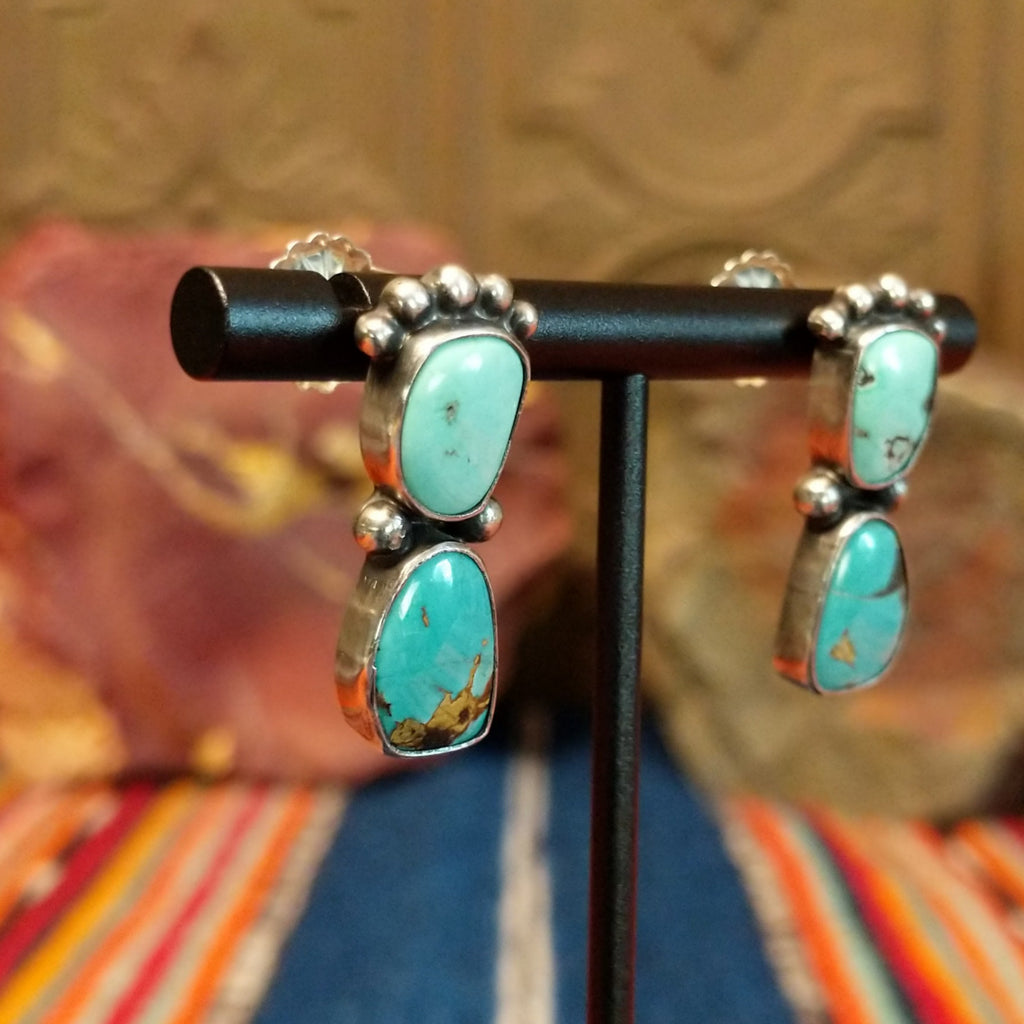 Two Chinese turquoise set in sterling silver bezels with dotted accents of the earrings.