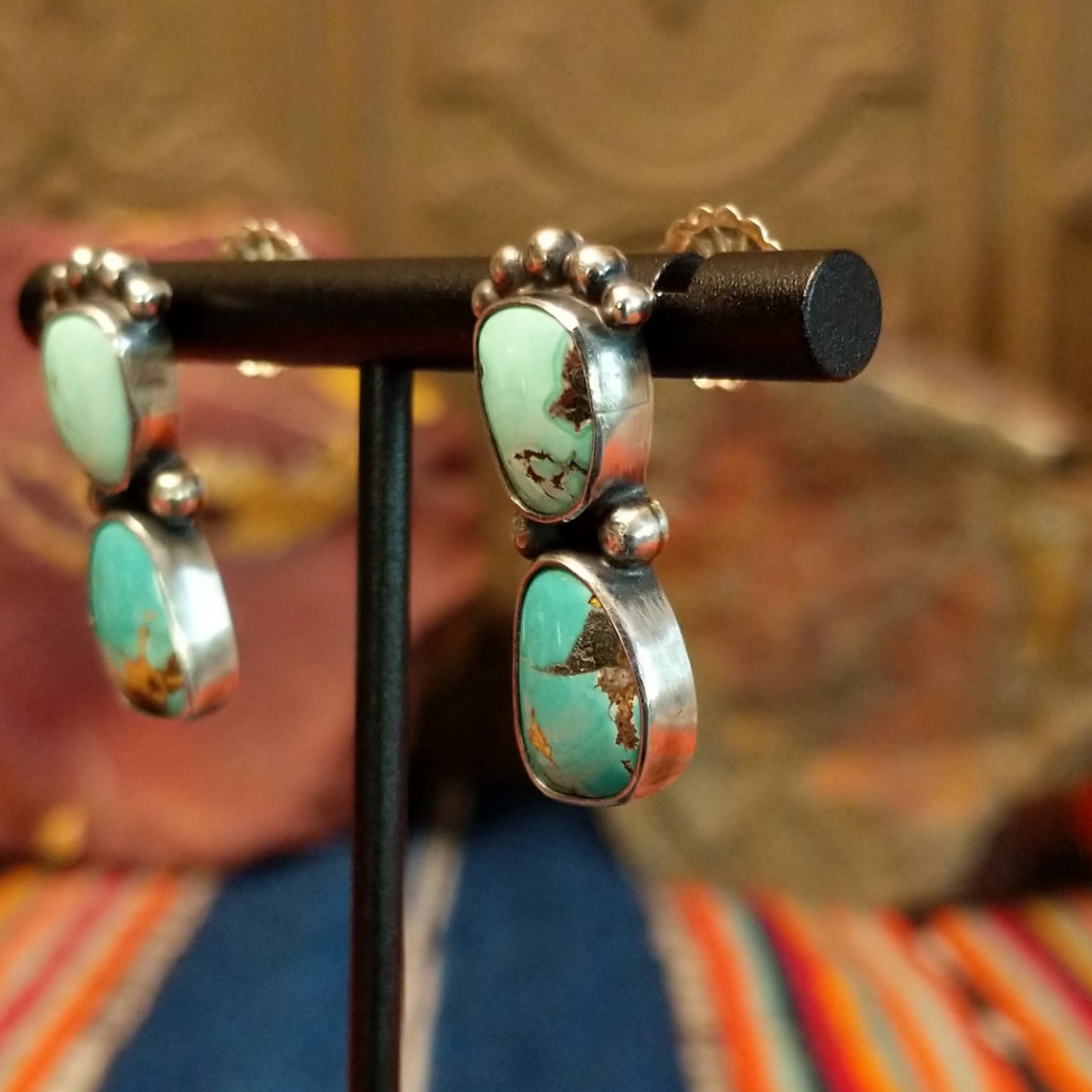 Two Chinese turquoise set in sterling silver bezels with dotted accents of the earrings.
