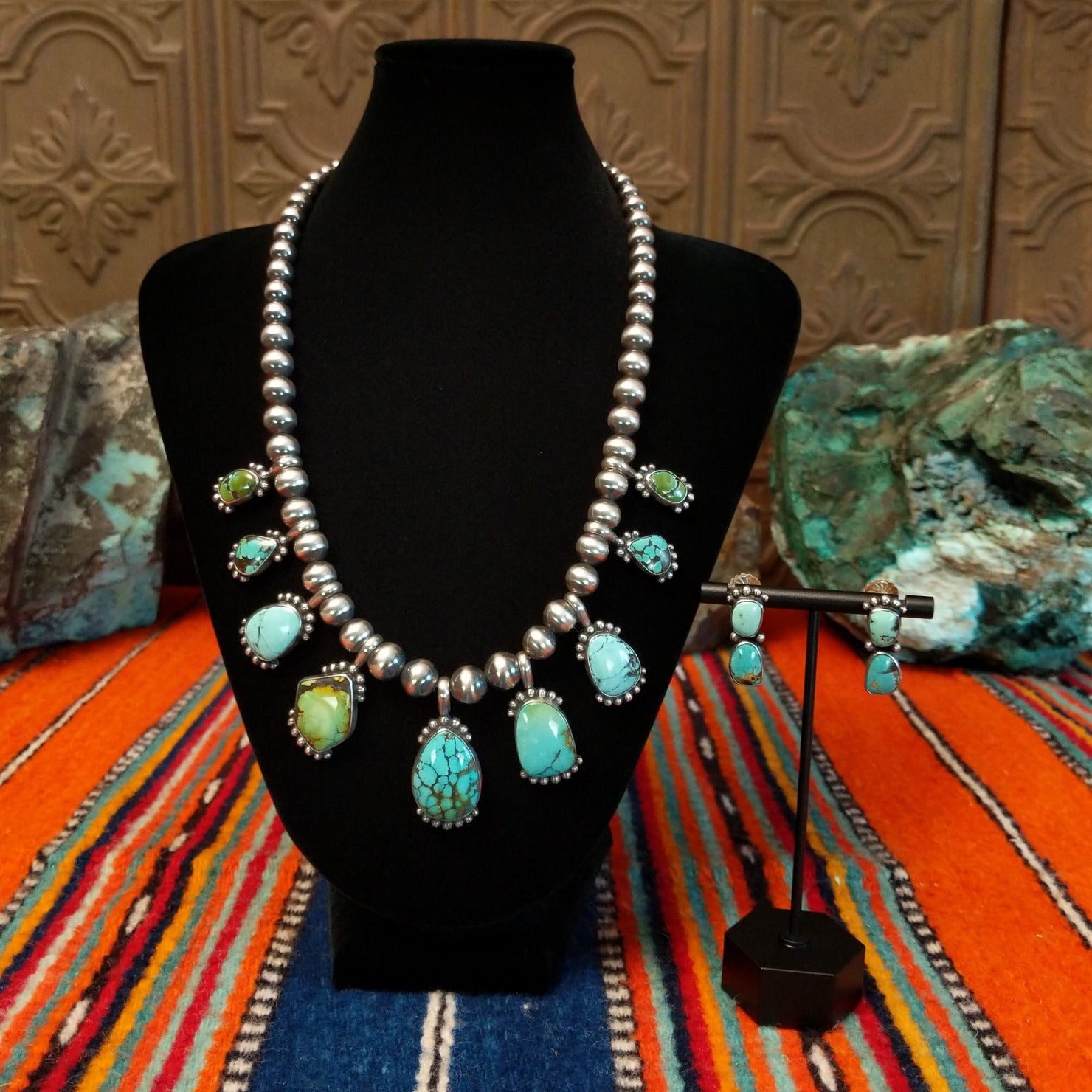 Chinese turquoise set in dotted bezels set along the sterling silver beaded chain with matching earrings.