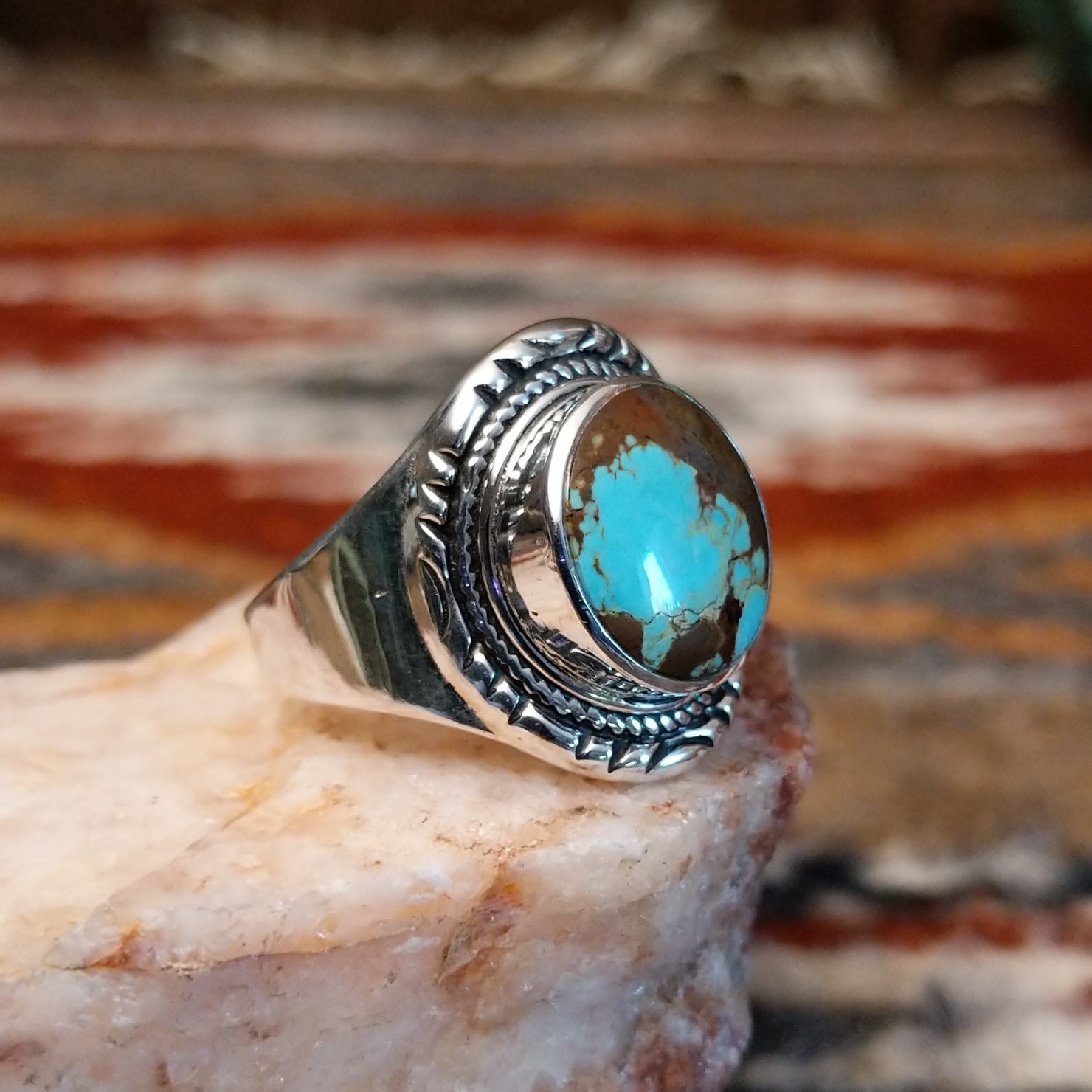 Circular boulder turquoise set within the bezel of the sterling silver ring.