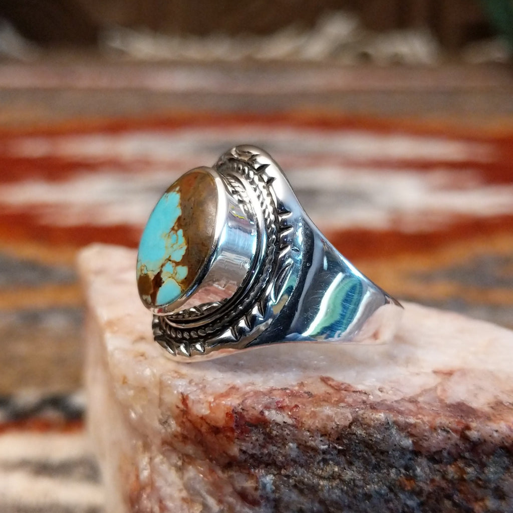 Circular boulder turquoise set within the bezel of the sterling silver ring.