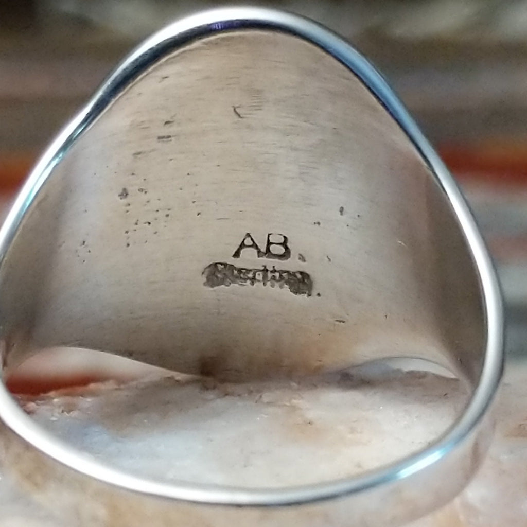 Close-up of the artisan's stamped initials.
