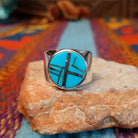 Circle Turquoise Inlay Ring by E.D. with crossed silver line details and wide polished band.