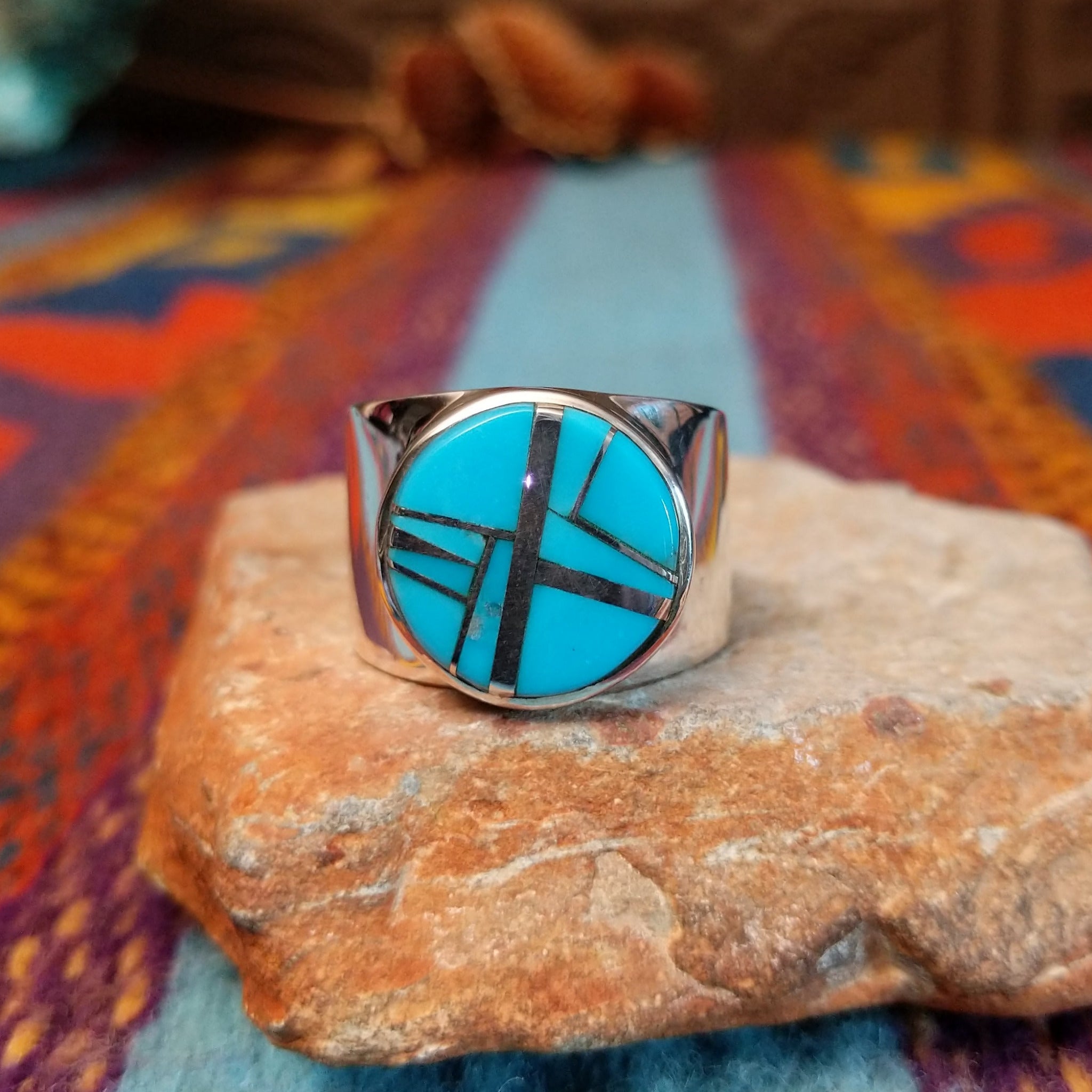 Circle Turquoise Inlay Ring by E.D. with crossed silver line details and wide polished band.
