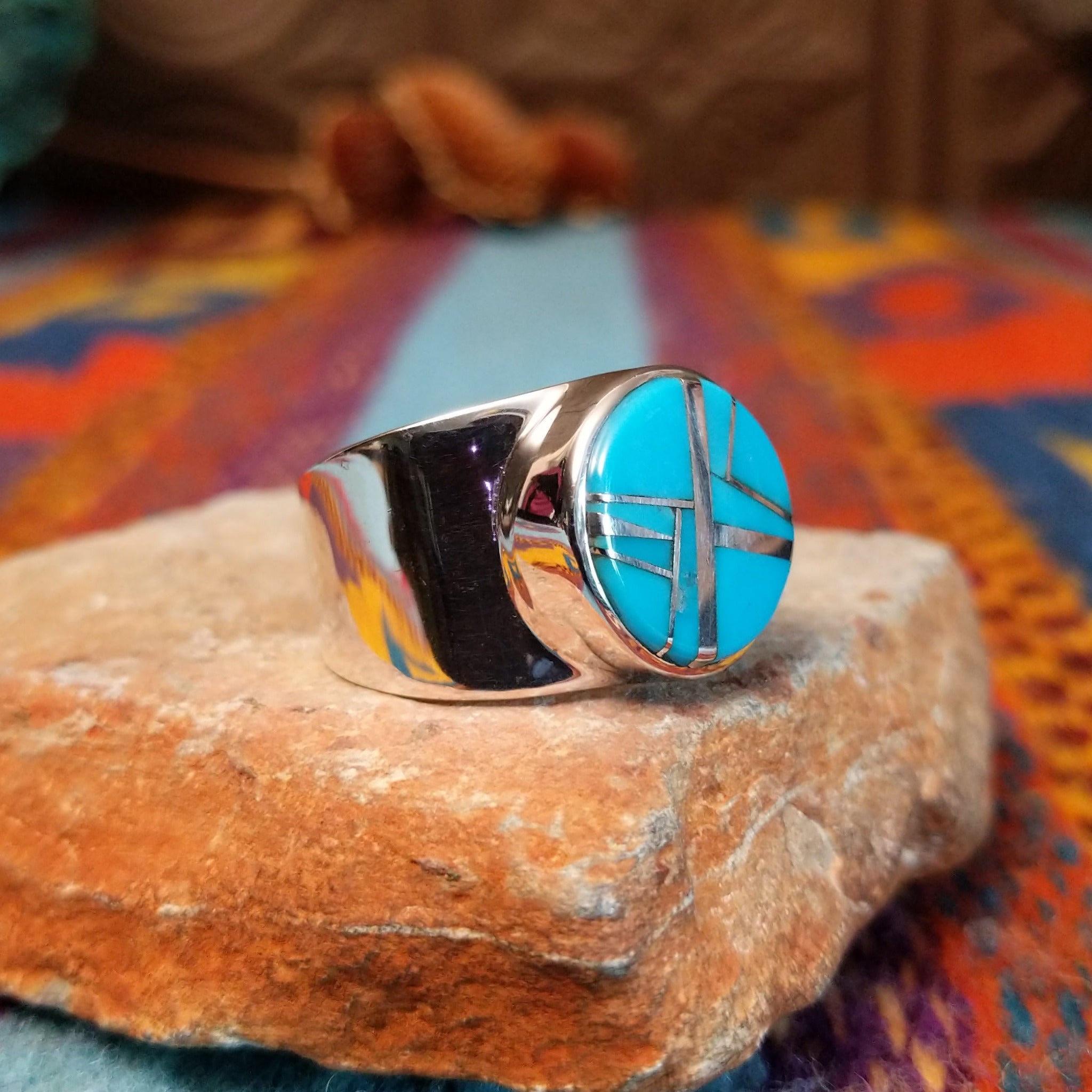 Circle Turquoise Inlay Ring by E.D. with crossed silver line details and wide polished band.
