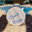 Underside of clown mini kachina doll showing handwritten signature and label on wood base.