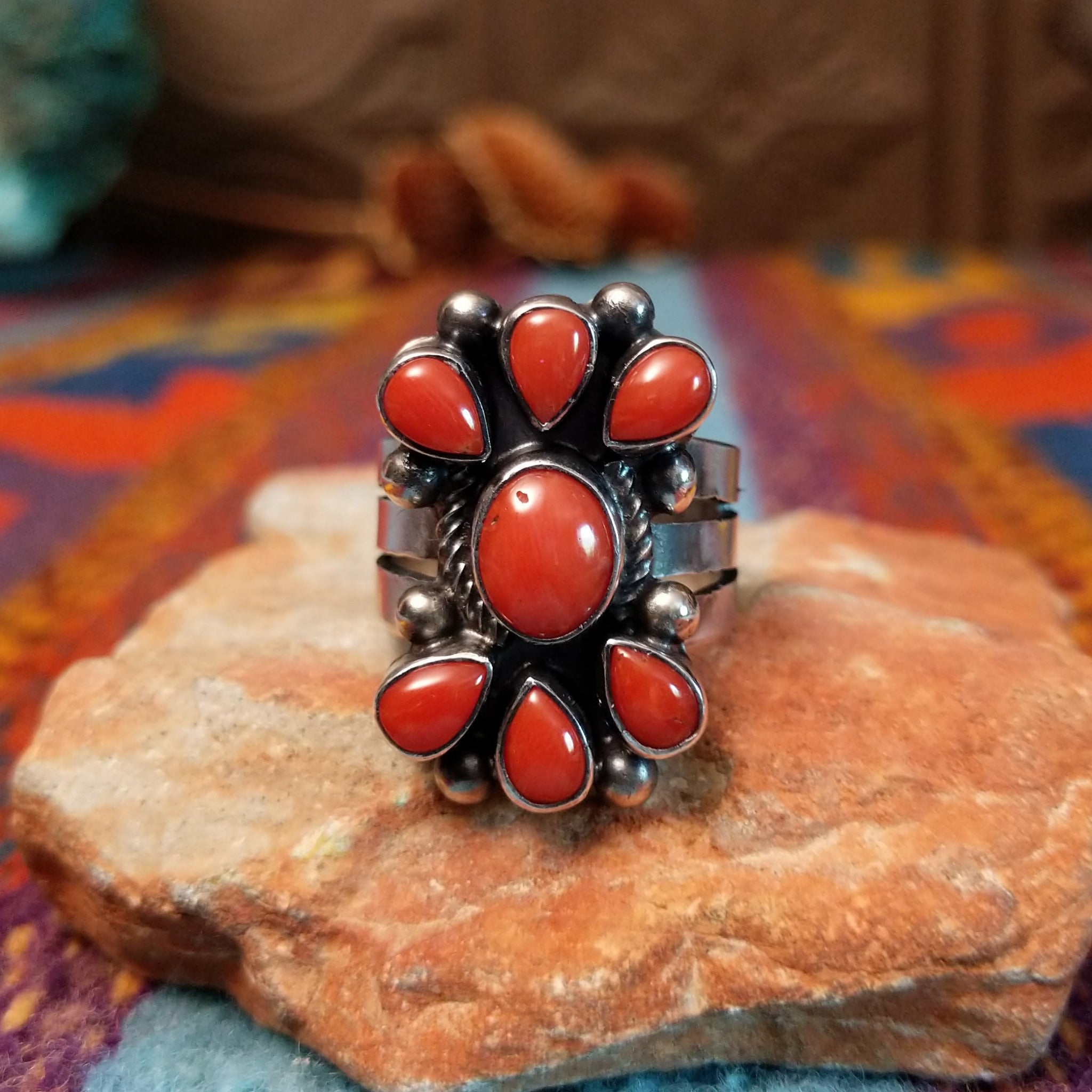 Coral Arrangement Ring by Kathleen Chavez featuring seven red coral stones set in Sterling Silver with polished silver beads and twisted silver accents.