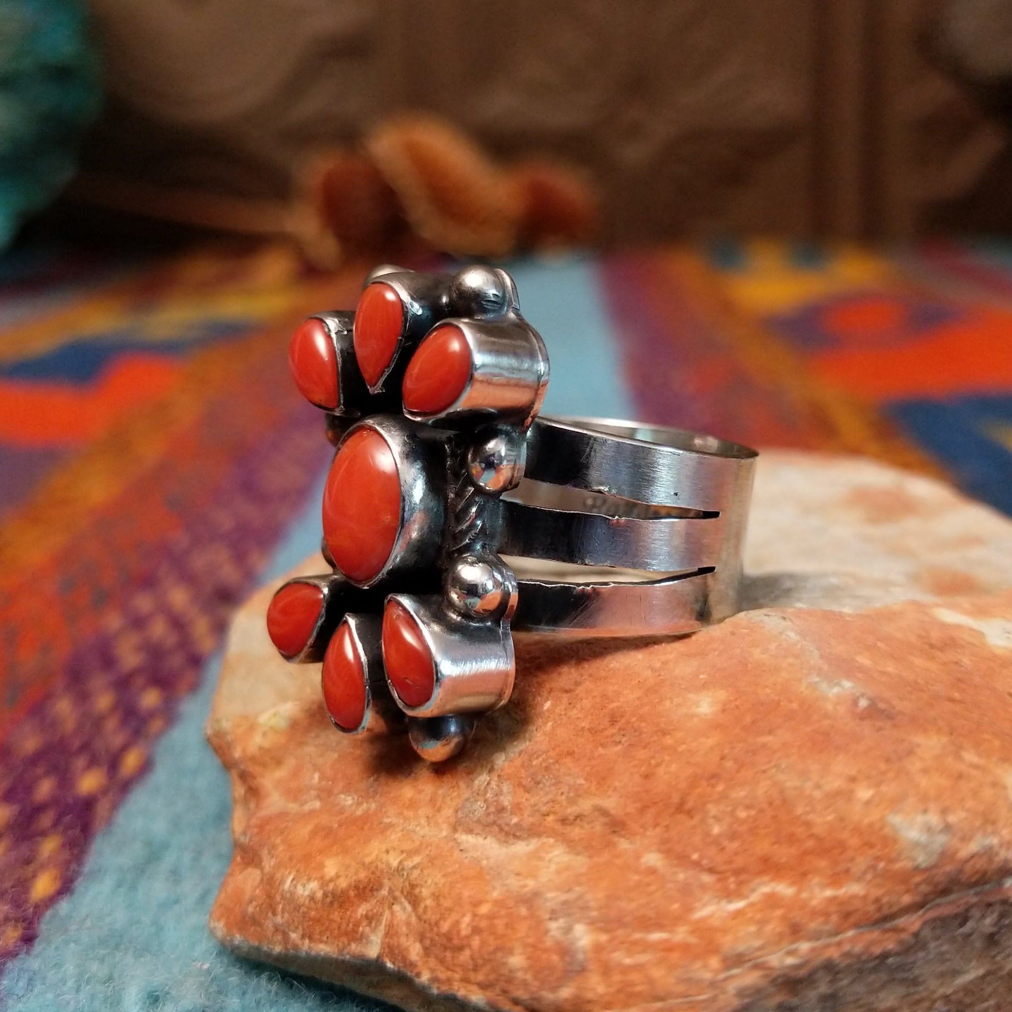 Coral Arrangement Ring by Kathleen Chavez featuring seven red coral stones set in Sterling Silver with polished silver beads and twisted silver accents; side view.