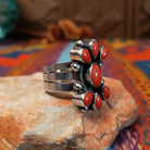 Coral Arrangement Ring by Kathleen Chavez featuring seven red coral stones set in Sterling Silver with polished silver beads and twisted silver accents; side view.