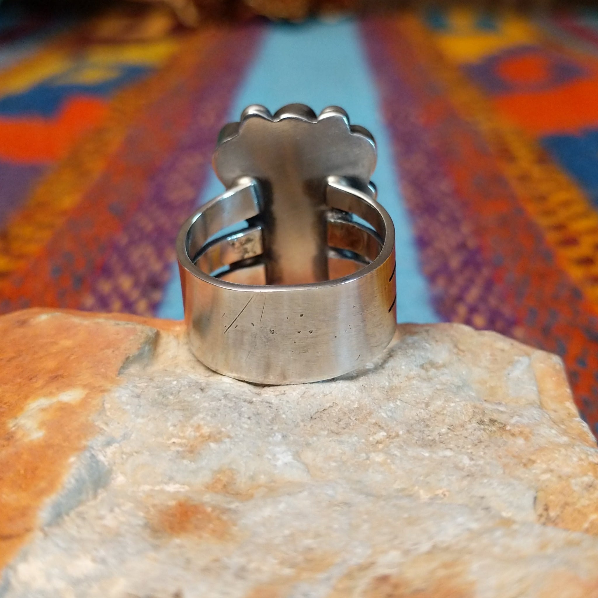 Coral Arrangement Ring by Kathleen Chavez featuring seven red coral stones set in Sterling Silver with polished silver beads and twisted silver accents; underside view.