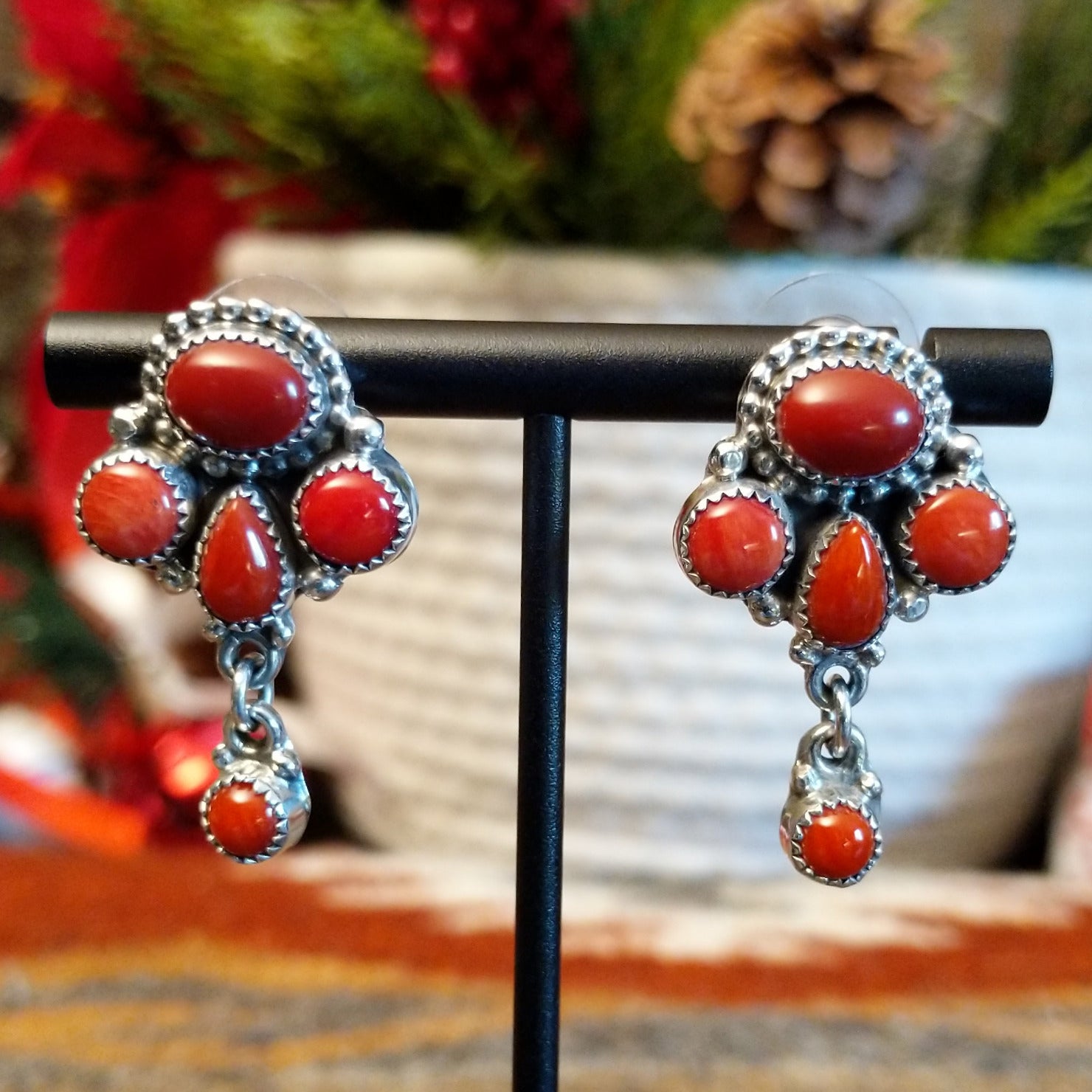 Sterling silver earrings with coral set in notched bezels.