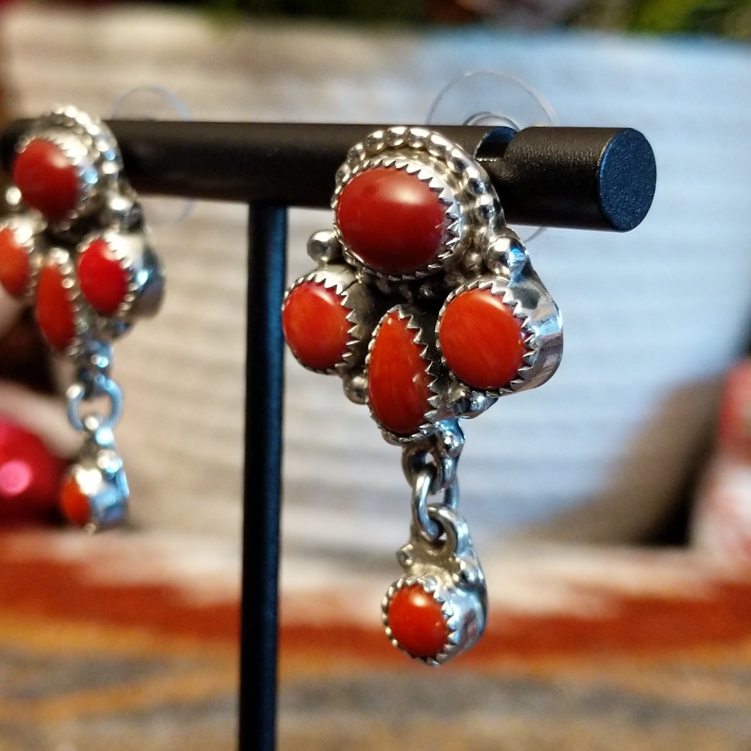 Sterling silver earrings with coral set in notched bezels.