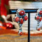 Sterling silver earrings with coral set in notched bezels.