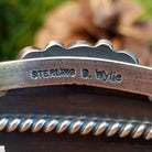 Close-up of the artisan's stamped signature.