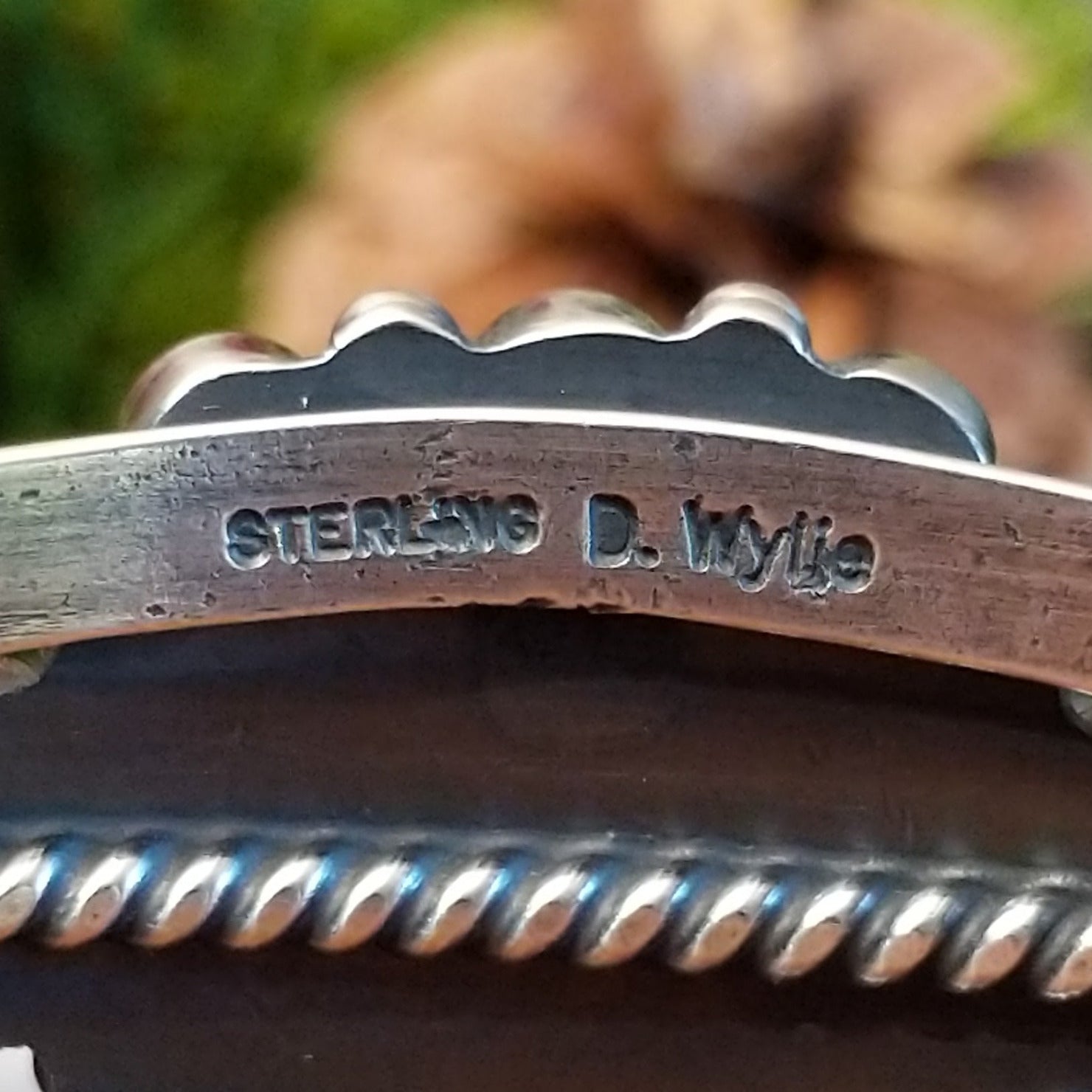 Close-up of the artisan's stamped signature.