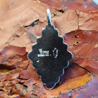 Close-up of the artisan's stamped signature.