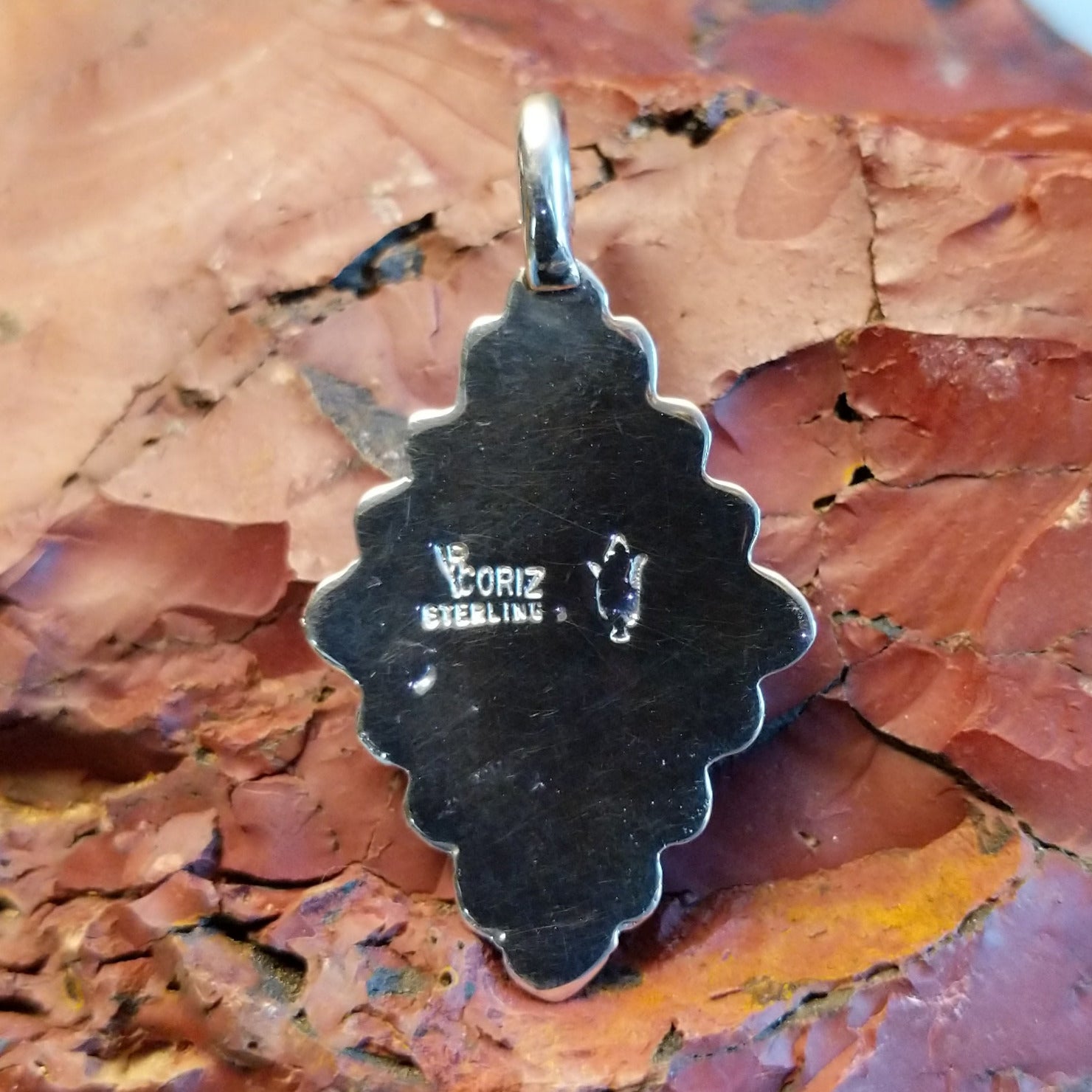 Close-up of the artisan's stamped signature.