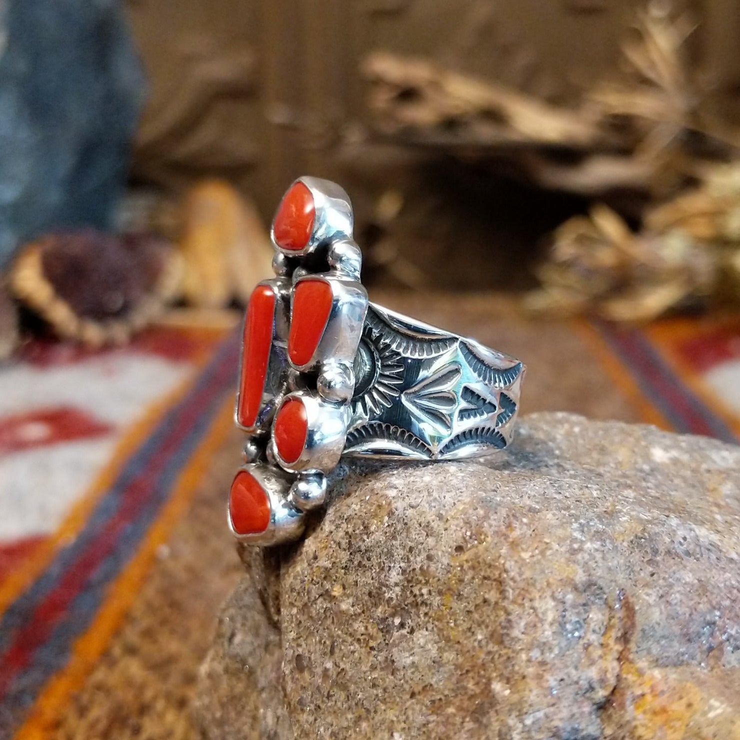 Sterling silver ring with coral set in various geometric shaped bezels.