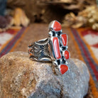 Sterling silver ring with coral set in various geometric shaped bezels.