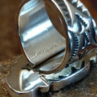 Close-up of the artisan's stamped signature.