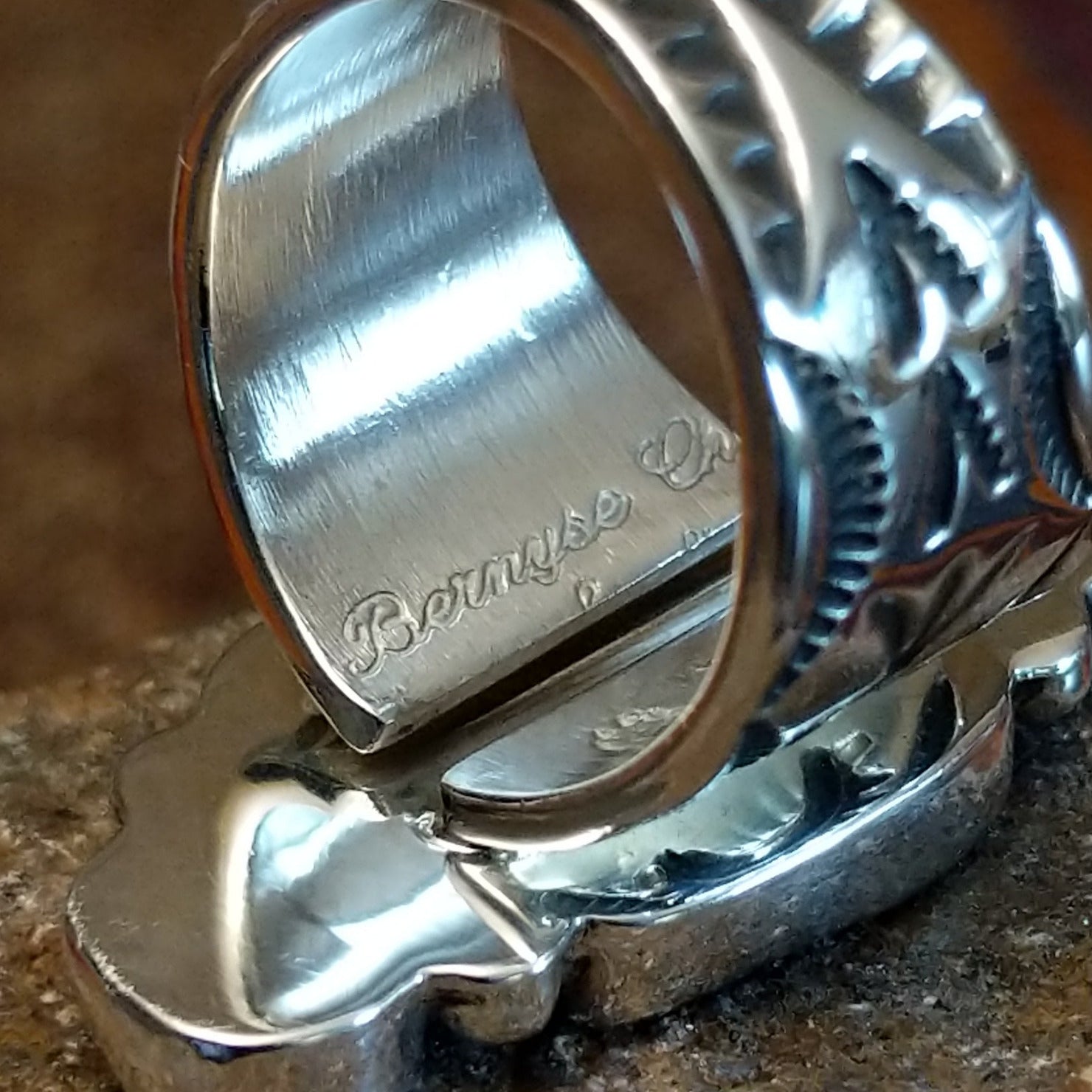Close-up of the artisan's stamped signature.