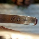 Close-up of the artisan's stamped signature.