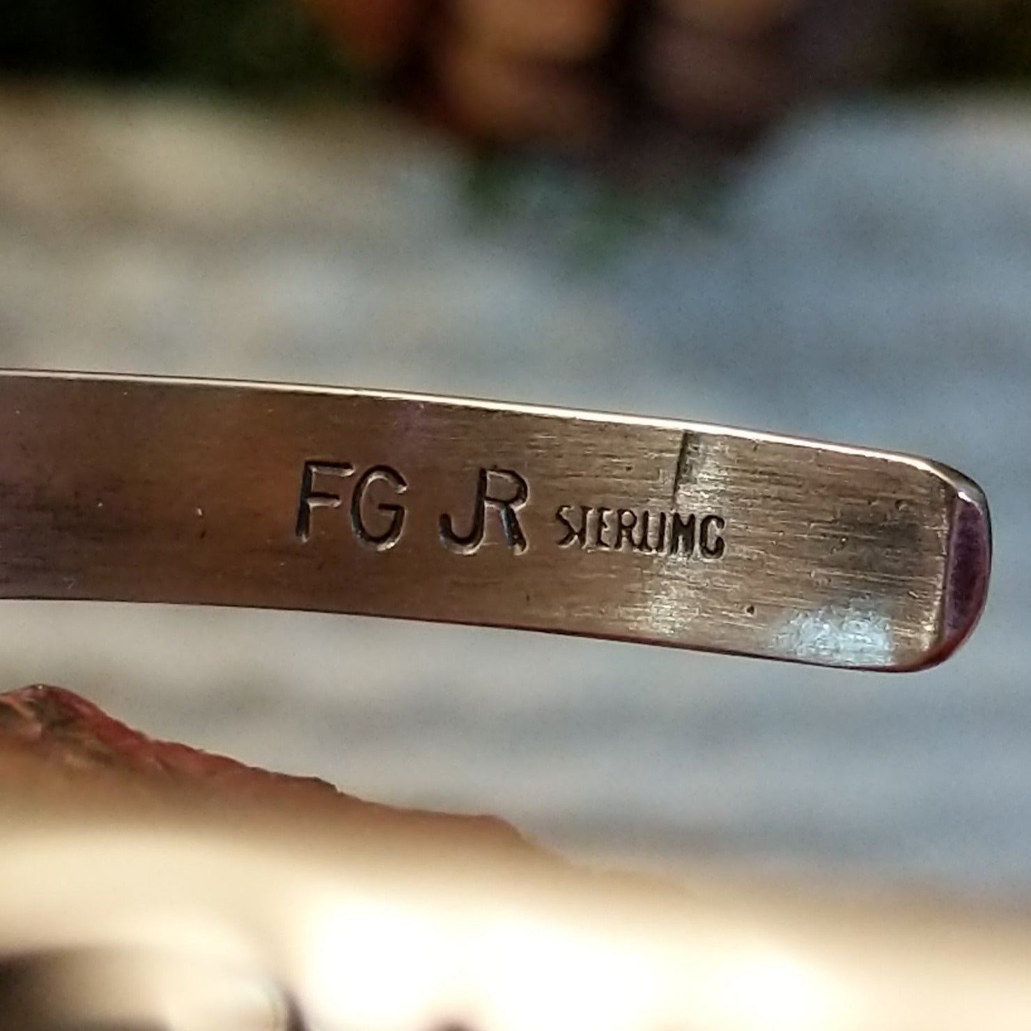 Close-up of the artisan's stamped signature.