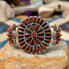 Handcrafted sterling silver cuff by Judy Wallace featuring a coral petitpoint concho centerpiece with matching side conchos, twisted rope detailing, silver bead accents, and a triple-shank cuff.