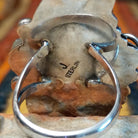 Coral & Turquoise Feather Ring by Jason Livingston featuring an oval turquoise stone, two elongated coral stones, intricate silver feather detailing, decorative scrollwork, polished silver beads, and stamped accents in an elaborate Southwestern design; artisan and Sterling Silver stamp.