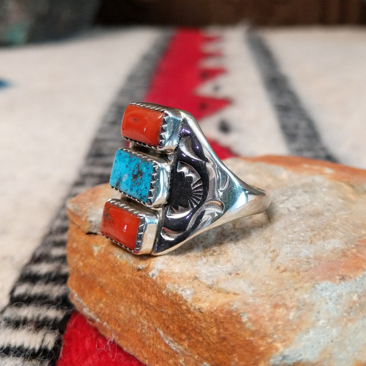 Coral and turquoise silver ring by Pauline Nelson with curved stamped silverwork.