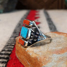 Coral and turquoise silver ring by Pauline Nelson with stamped motifs.