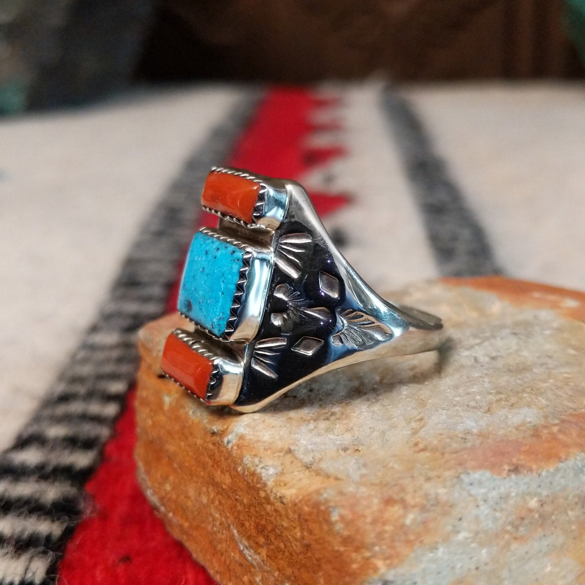 Coral and turquoise silver ring by Pauline Nelson with stamped motifs.