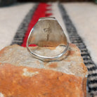 Coral and turquoise silver ring by Pauline Nelson with stamped motifs.