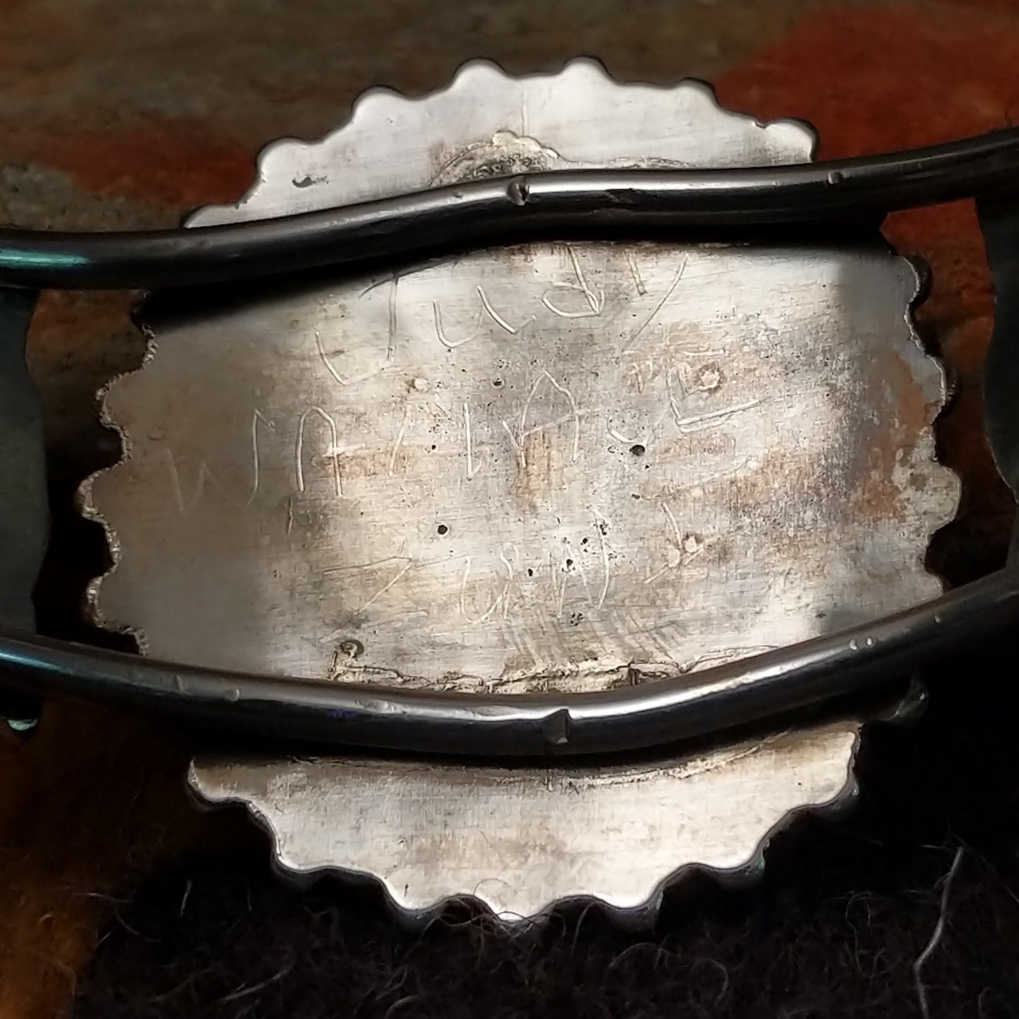 Handcrafted sterling silver cuff by Judy Wallace featuring a coral petitpoint concho centerpiece with matching side conchos, twisted rope detailing, silver bead accents, and a triple-shank cuff; artisan and tribe stamp.