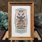 Framed Navajo sand painting of the Corn Maiden with symbolic motifs. 