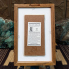 Backside of the Corn Maiden sand painting, showing the Certificate of Authenticity and Artist information. 