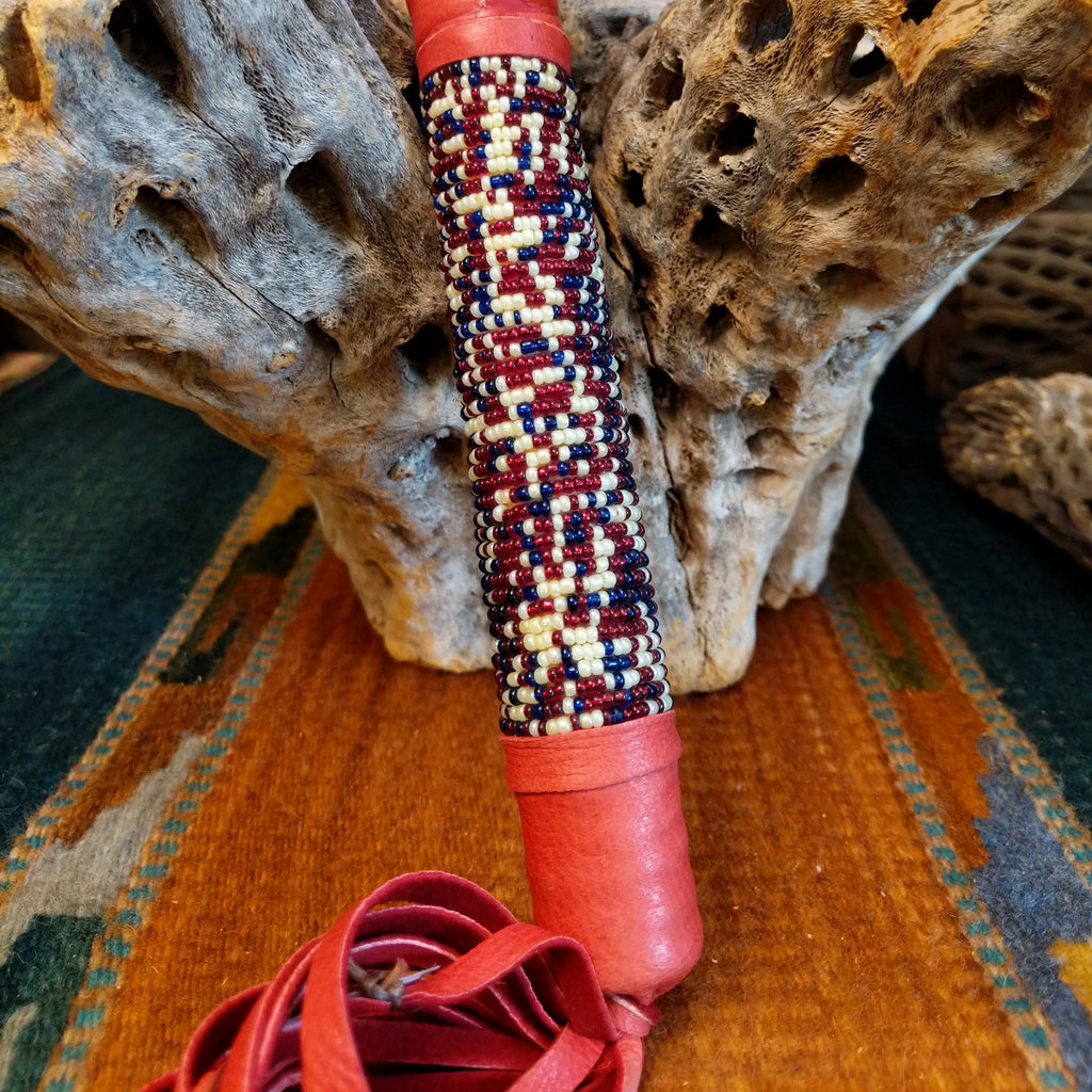 The bottom of the shaft is decorated with colorful beading and red leather.