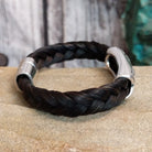 A braided black horsehair bracelet with an ornate crossed arrows accent and magnetic clasp.