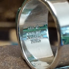 Close-up of the artisan's stamped signature.