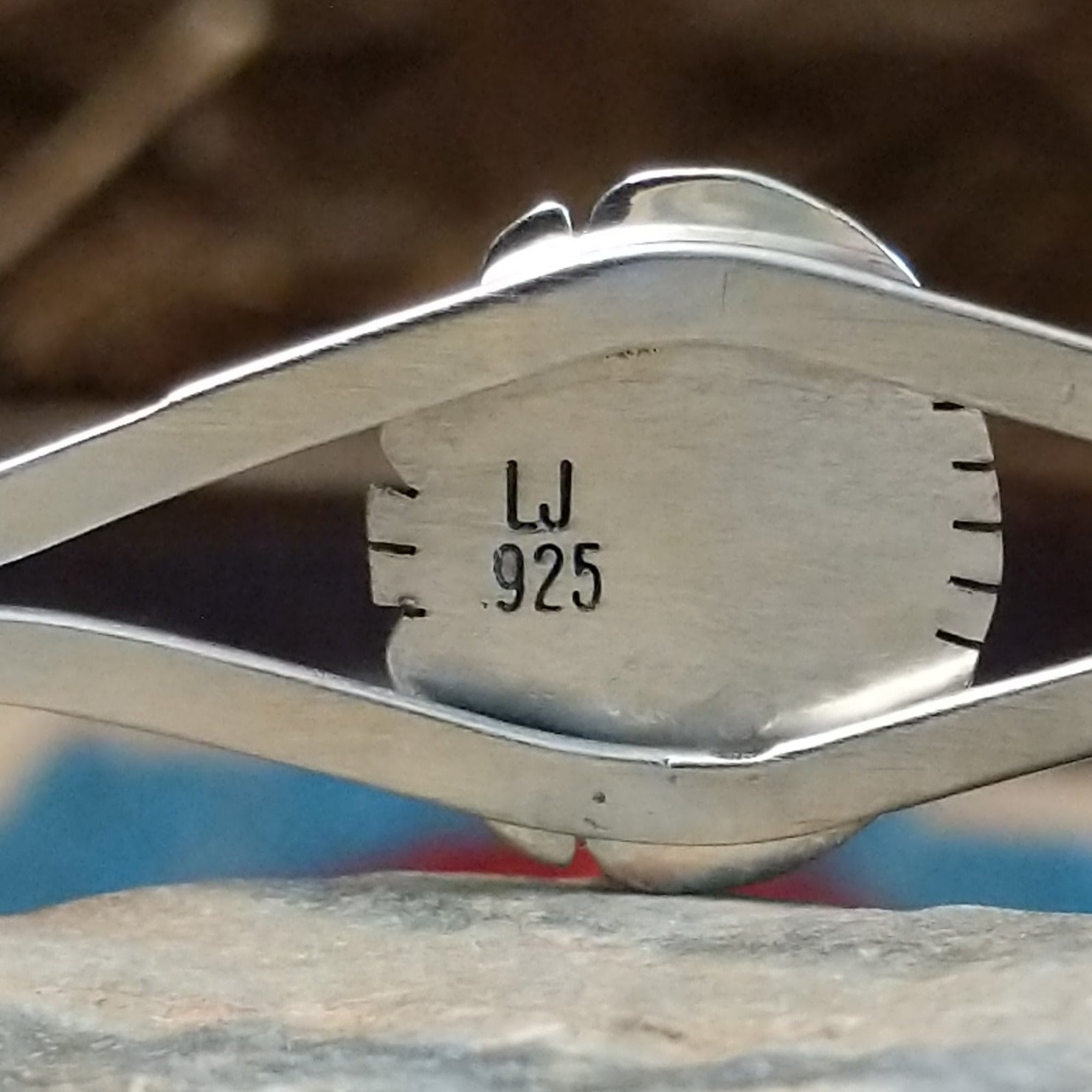Close-up of the artisan's stamped signature.