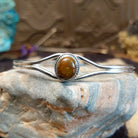 Sterling silver cuff with Boulder turquoise set in a round bezel, framed by twisted rope and silverwork band.