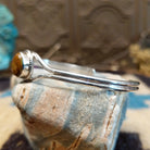 Sterling silver cuff with Boulder turquoise set in a round bezel, framed by twisted rope and silverwork band.