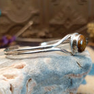 Sterling silver cuff with Boulder turquoise set in a round bezel, framed by twisted rope and silverwork band.