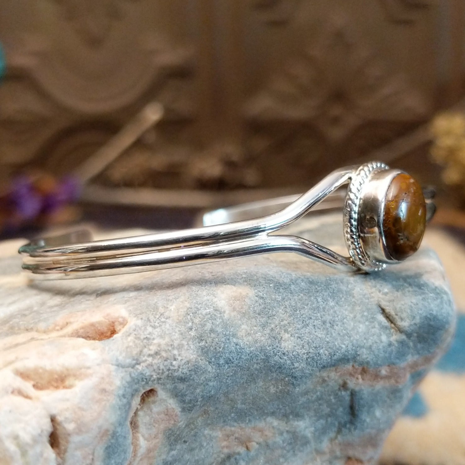 Sterling silver cuff with Boulder turquoise set in a round bezel, framed by twisted rope and silverwork band.
