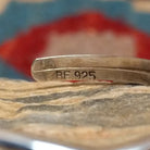 Close-up of the artisan's stamped signature.