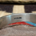 Deep stamped sterling silver cuff by Jerrold Tahe, featuring bold hand-stamped patterns with deep texture on a handcrafted open sterling silver cuff.  Sterling Silver stamp.