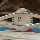 Close-up of the artisan's stamped signature.